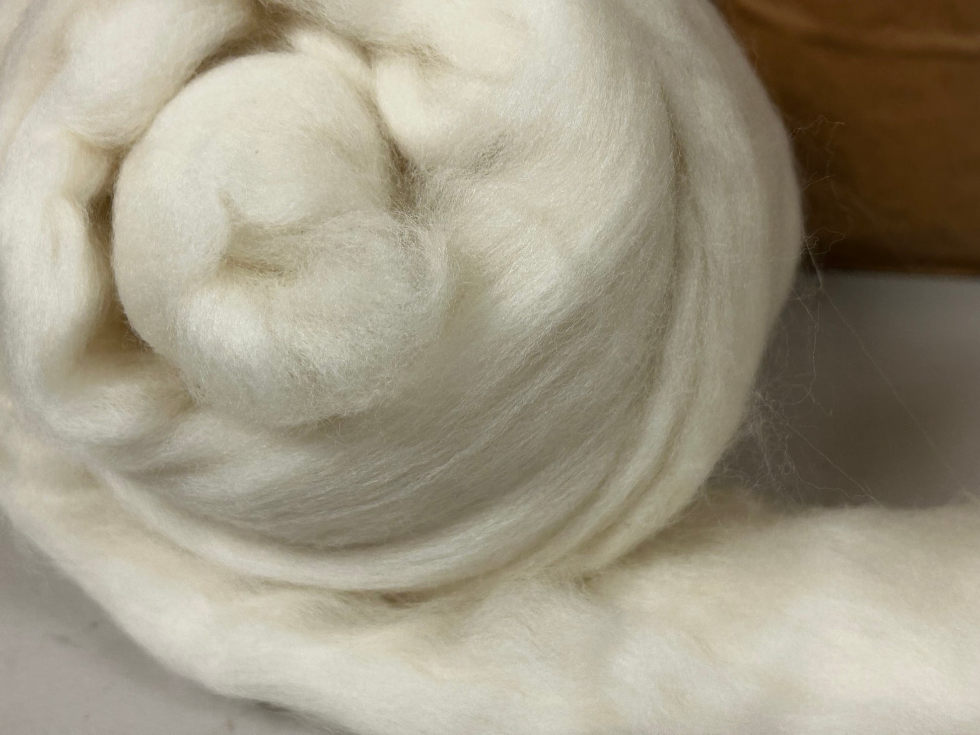 Closeup picture of natural undyed white Merino wool roving 