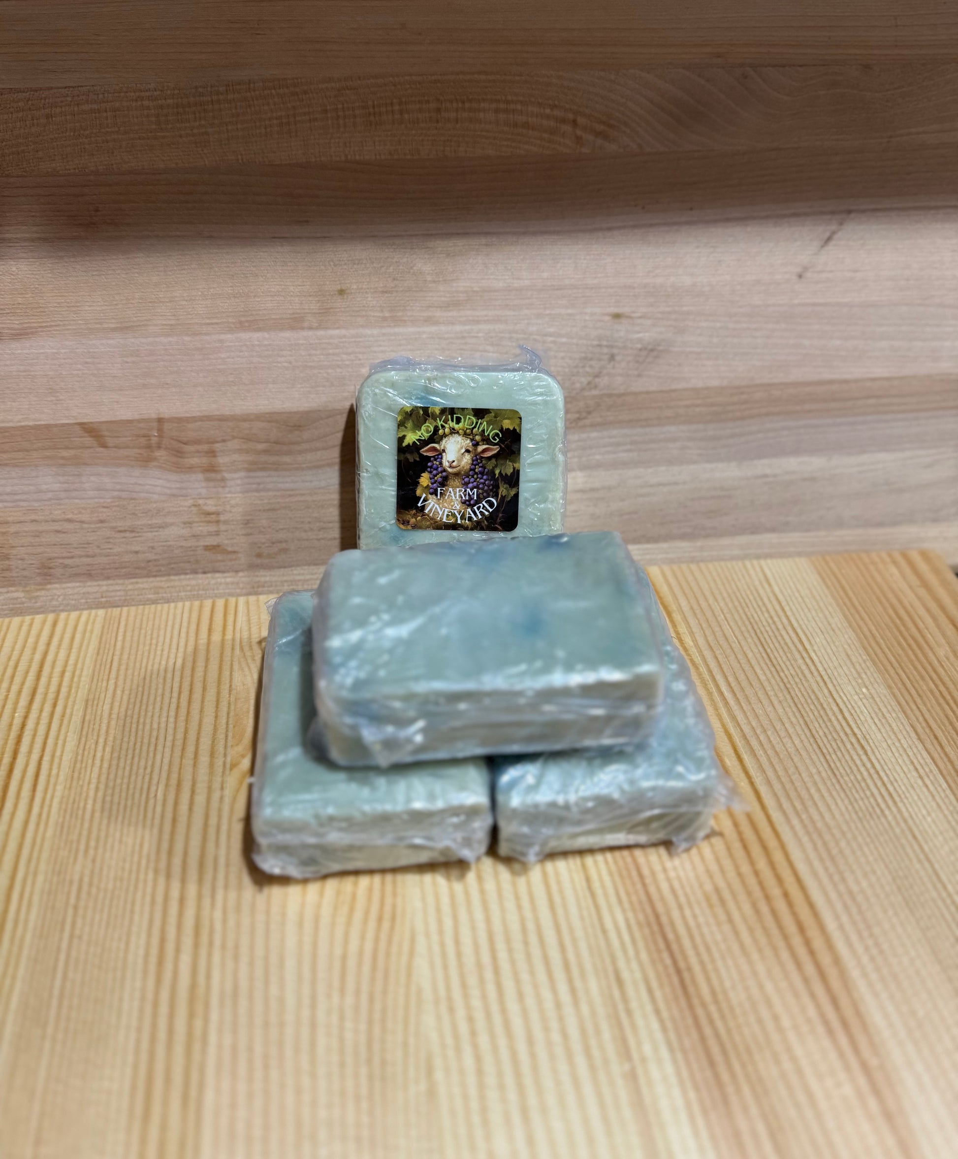 Stack of handmade Sandalwood and Clary Sage goat milk soap bars with No Kidding Farm label.