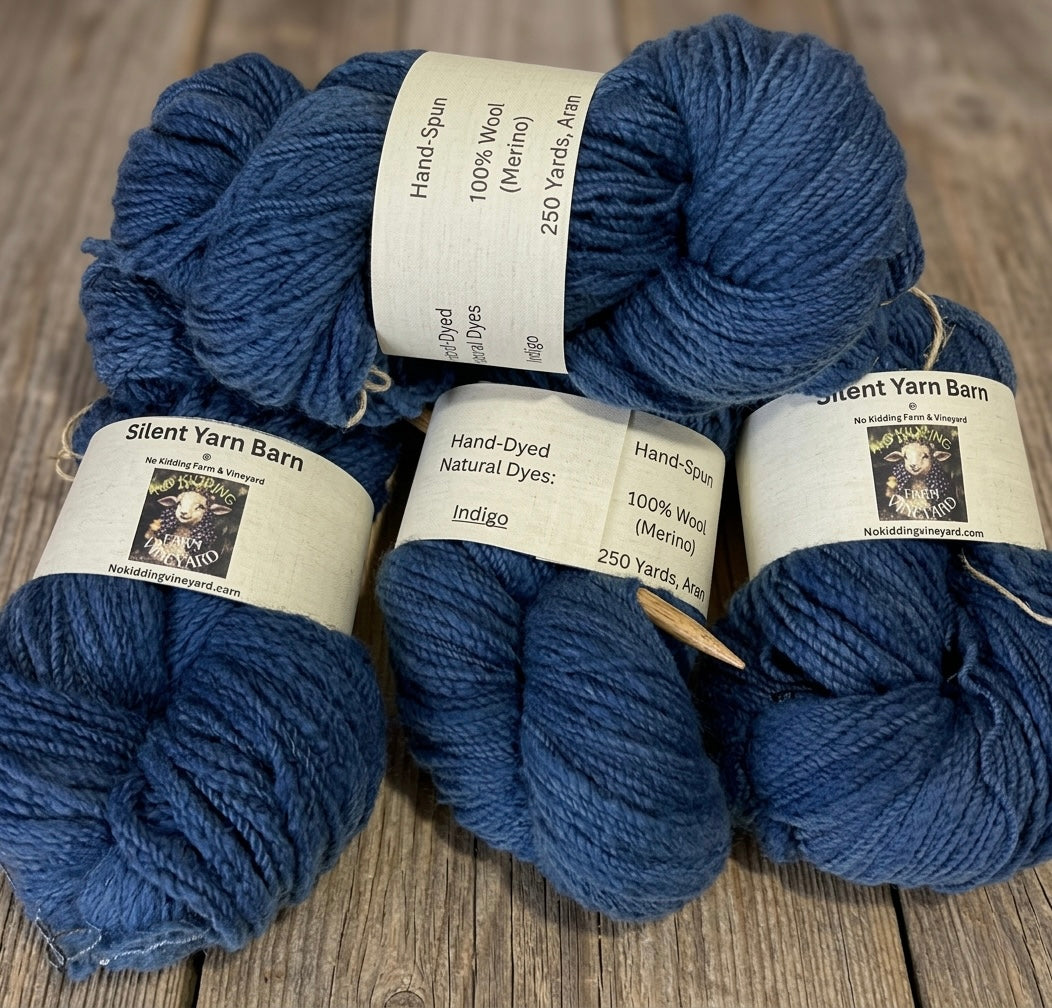 Four skeins of indigo blue yarn by No Kidding Farm and Vineyard on a wooden table