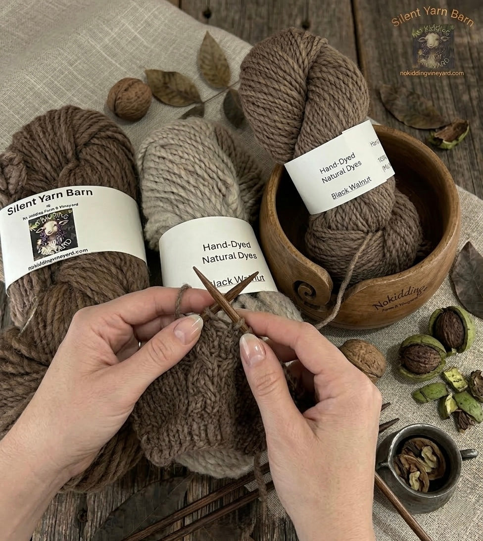 Three skeins of brown yarn with labels, a hand holding knitting needles, and natural elements on a wooden surface.