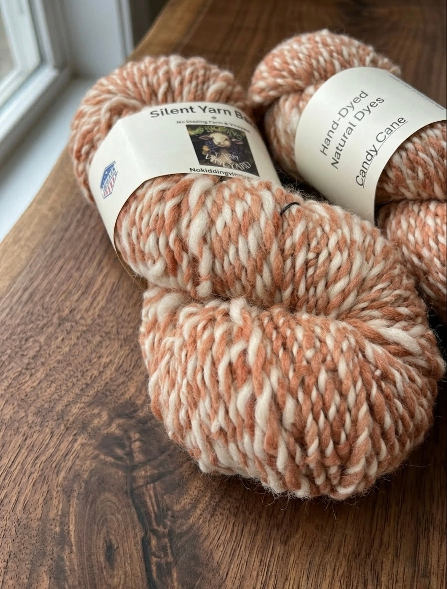 A closeup of the yarn texture on a wooden table 